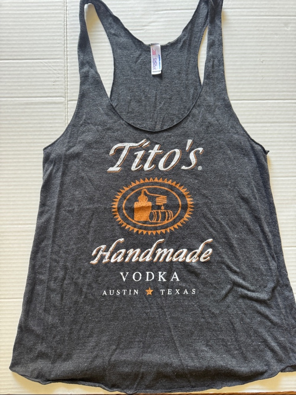 Tito’s Charcoal Racerback Tank with White & Orange Graphic